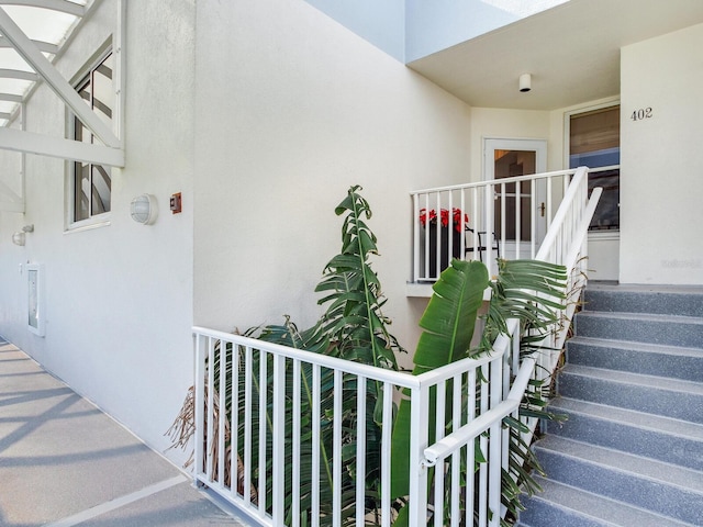 view of exterior entry featuring a balcony