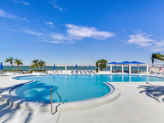 view of swimming pool with a gazebo and a water view