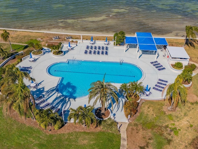 view of swimming pool with a patio area and a water view