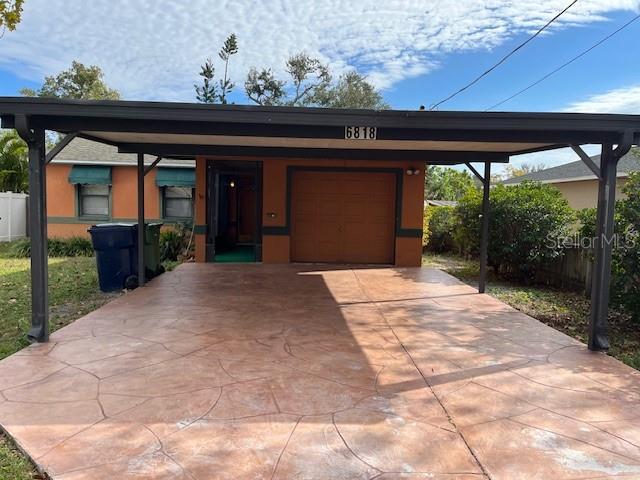 view of front facade featuring a garage and a carport