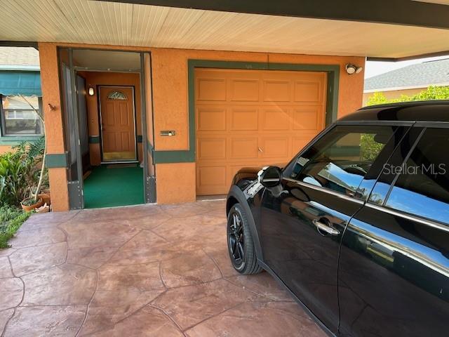 garage with concrete driveway