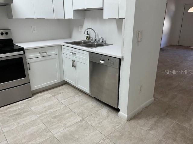 kitchen with stainless steel appliances, a sink, white cabinets, light countertops, and ventilation hood