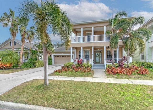 view of front of property with a balcony, a garage, covered porch, and a front yard