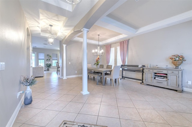 tiled dining area with ornate columns, crown molding, an inviting chandelier, and a tray ceiling