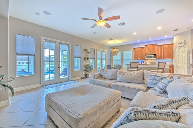 living room featuring light tile patterned floors, french doors, and ceiling fan