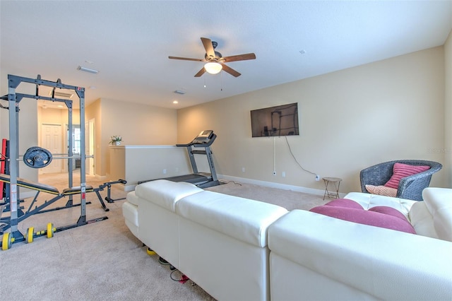 carpeted living room with ceiling fan