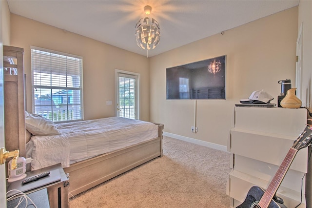 carpeted bedroom with a chandelier