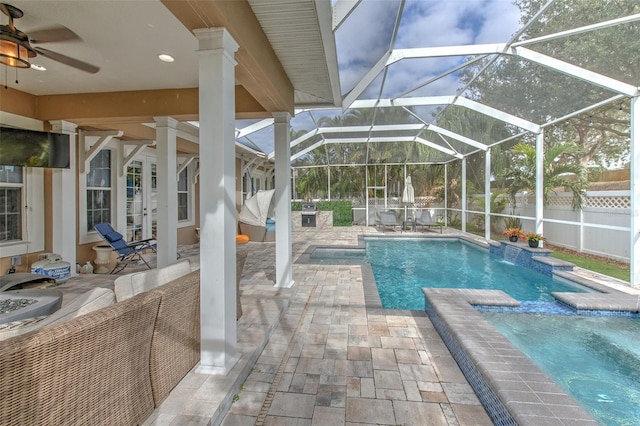 view of swimming pool with a lanai, pool water feature, a patio, and ceiling fan