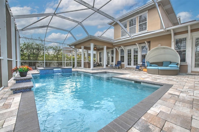 view of pool featuring french doors, a lanai, an in ground hot tub, ceiling fan, and a patio