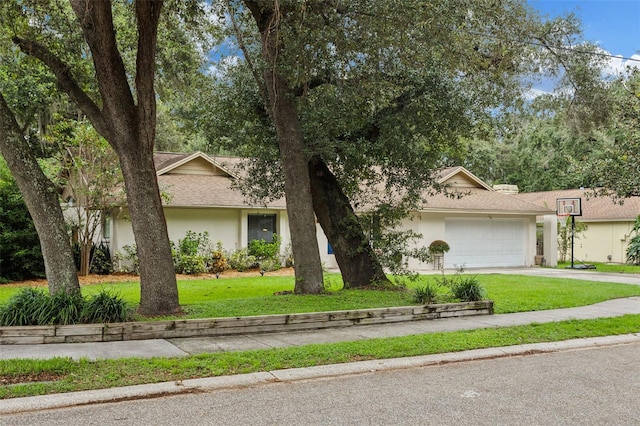 view of front of property with a front lawn and a garage