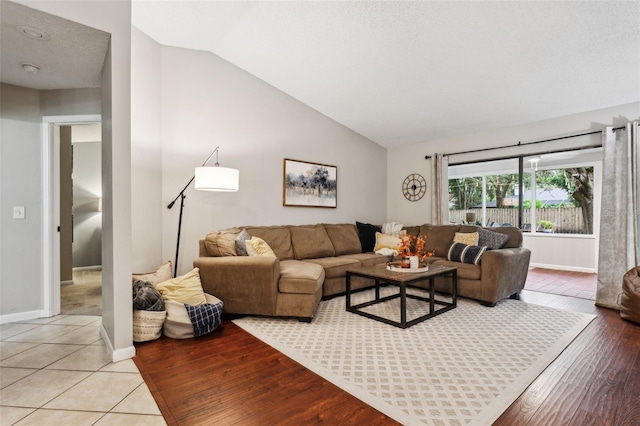 tiled living room with lofted ceiling