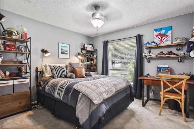 bedroom with ceiling fan, carpet floors, and a textured ceiling