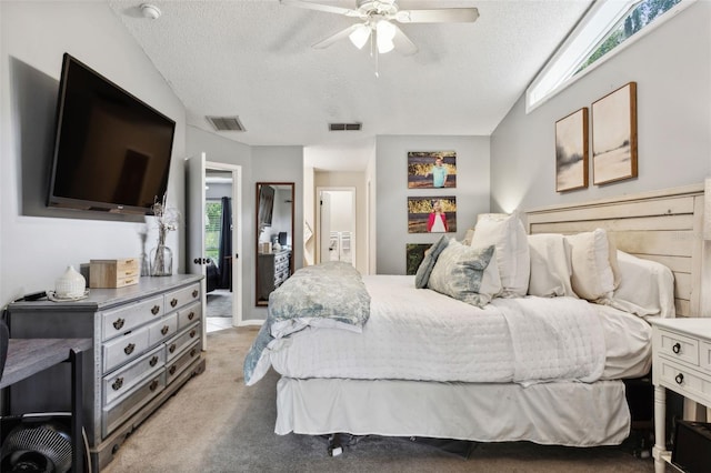 carpeted bedroom featuring vaulted ceiling, a textured ceiling, and ceiling fan