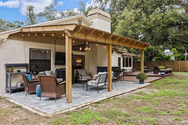 rear view of property with an outdoor living space and a patio