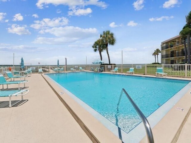 view of swimming pool with a patio