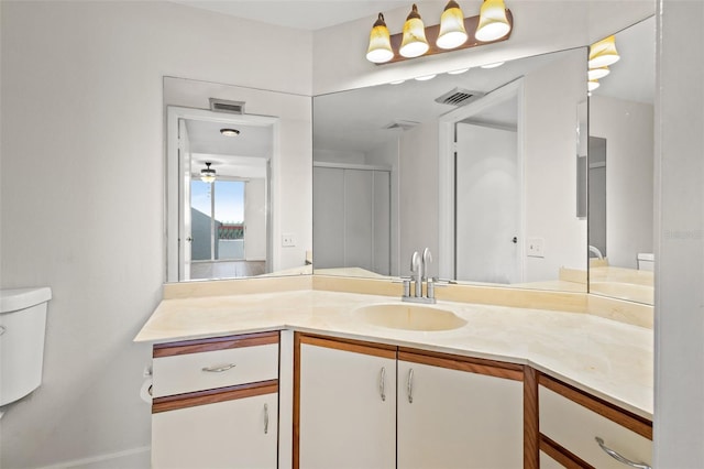 bathroom with toilet, an enclosed shower, and vanity