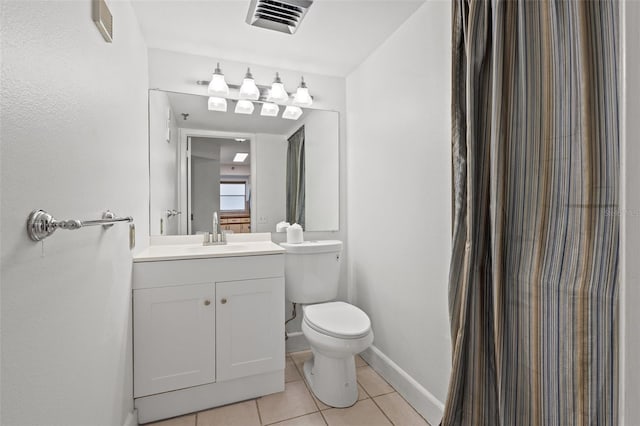 bathroom with toilet, tile patterned floors, and vanity