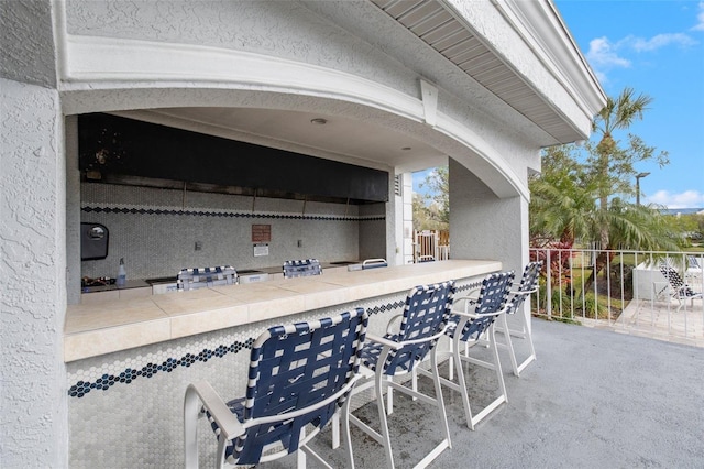 view of patio / terrace featuring an outdoor bar