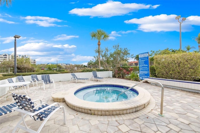 view of swimming pool featuring a community hot tub and a patio