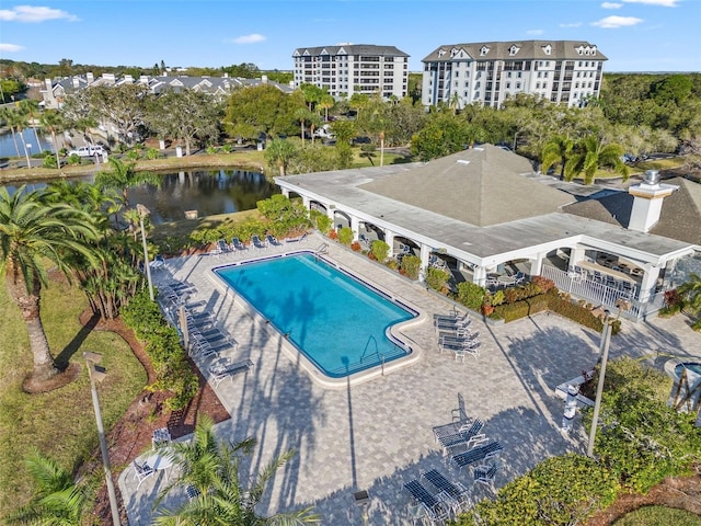 view of swimming pool with a water view and a patio area