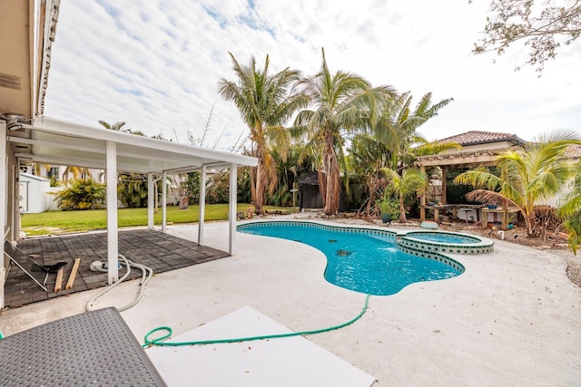 view of swimming pool with a patio and an in ground hot tub