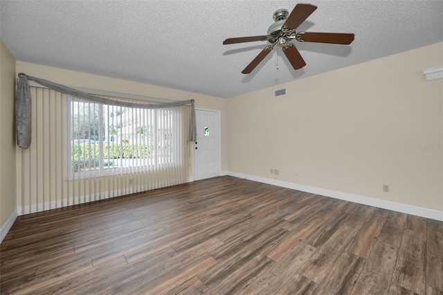 unfurnished room featuring a textured ceiling and dark hardwood / wood-style flooring