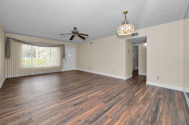 unfurnished living room featuring ceiling fan, dark wood-type flooring, and a textured ceiling