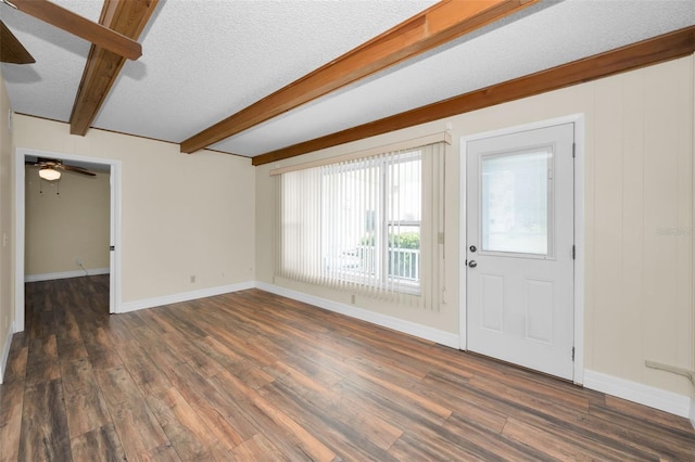 interior space featuring dark hardwood / wood-style flooring, ceiling fan, a textured ceiling, and beam ceiling