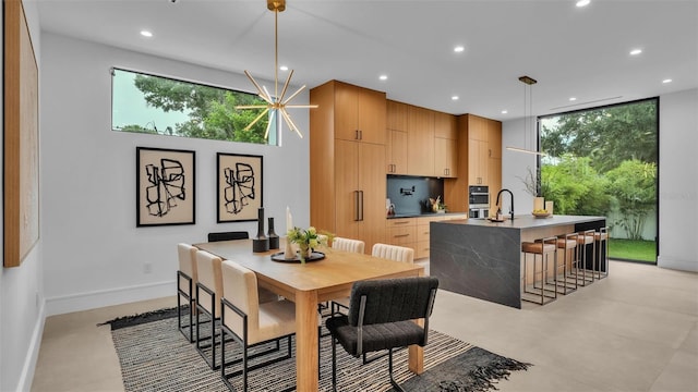 dining room featuring sink and an inviting chandelier