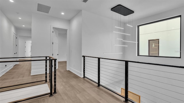 hallway with light hardwood / wood-style flooring