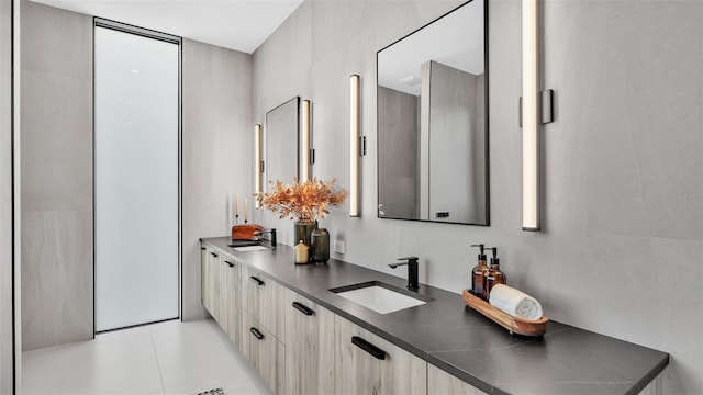 bathroom with tile patterned floors and vanity