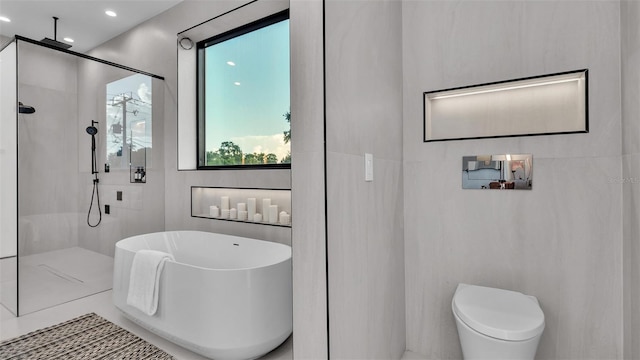 bathroom featuring toilet, tile walls, and separate shower and tub