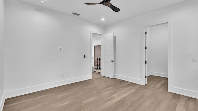 spare room featuring light wood-type flooring and ceiling fan