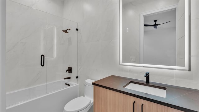 full bathroom with toilet, bathtub / shower combination, tile walls, and vanity