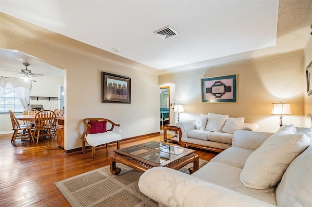 living room featuring ceiling fan and hardwood / wood-style flooring