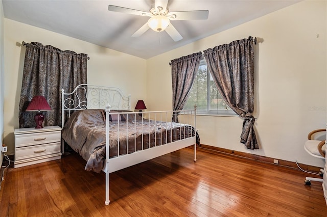 bedroom with ceiling fan and wood-type flooring