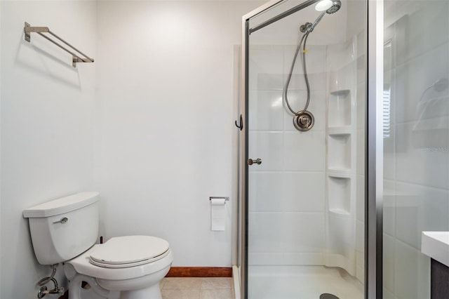 bathroom featuring a shower with shower door, toilet, and tile patterned flooring