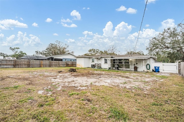 rear view of property featuring a yard