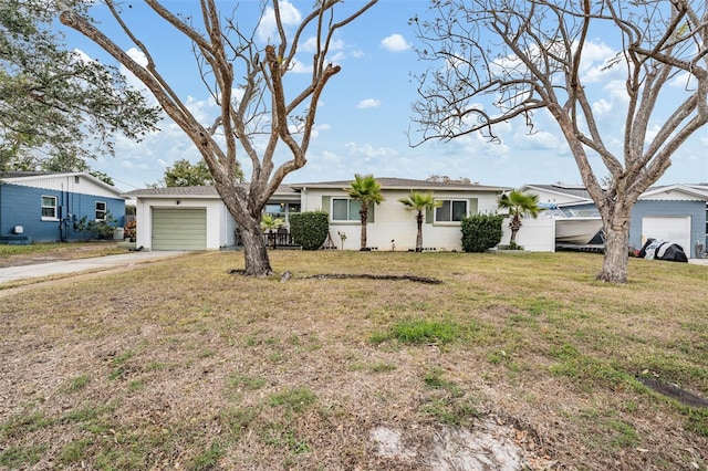 ranch-style house with a garage and a front lawn