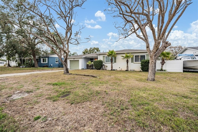 ranch-style house with a front yard and a garage