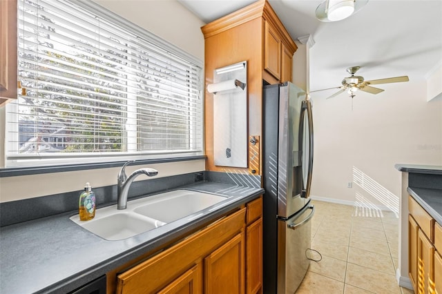 kitchen with light tile patterned floors, stainless steel fridge, ceiling fan, sink, and dishwashing machine