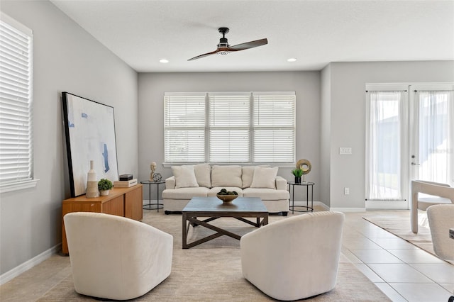 living room featuring ceiling fan, french doors, and light tile patterned floors