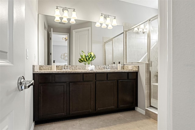 bathroom with vanity, tile patterned flooring, and a shower with shower door