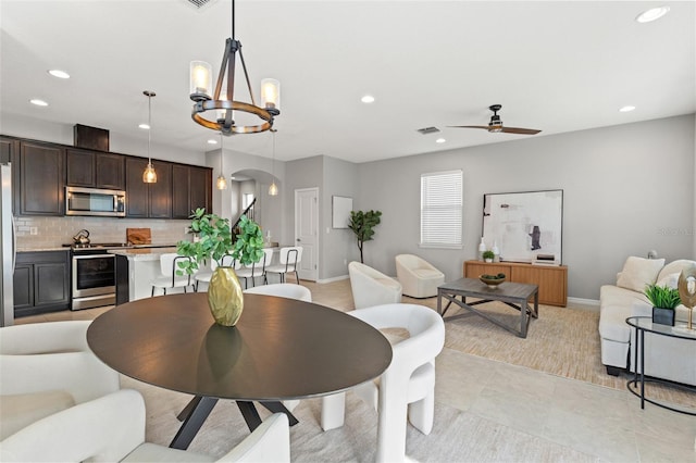 dining room featuring ceiling fan with notable chandelier