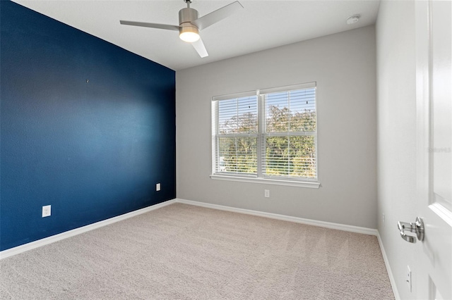 spare room with carpet floors and ceiling fan