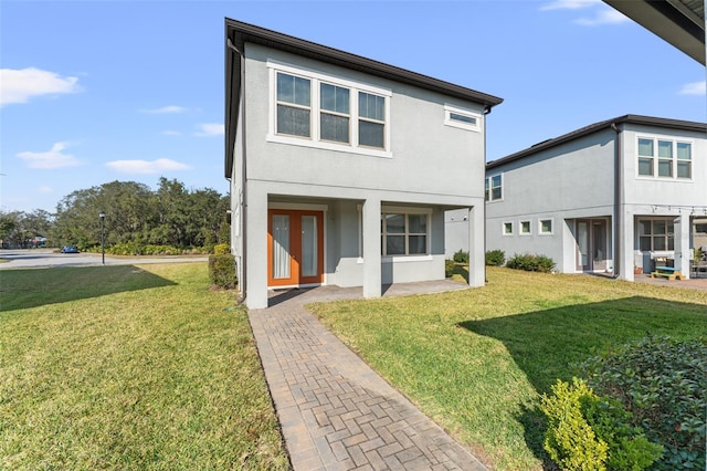 back of house with a patio and a lawn