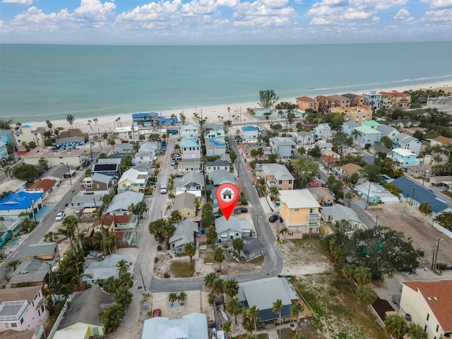 drone / aerial view featuring a beach view and a water view