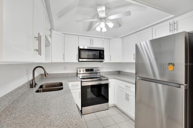 kitchen with stainless steel appliances, light stone countertops, ceiling fan, sink, and white cabinetry