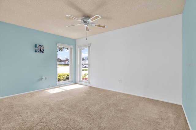 unfurnished room with carpet flooring, a textured ceiling, and ceiling fan