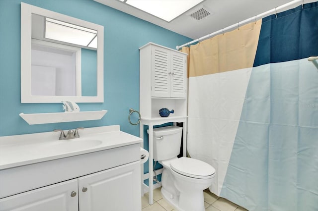 bathroom featuring curtained shower, tile patterned flooring, vanity, and toilet